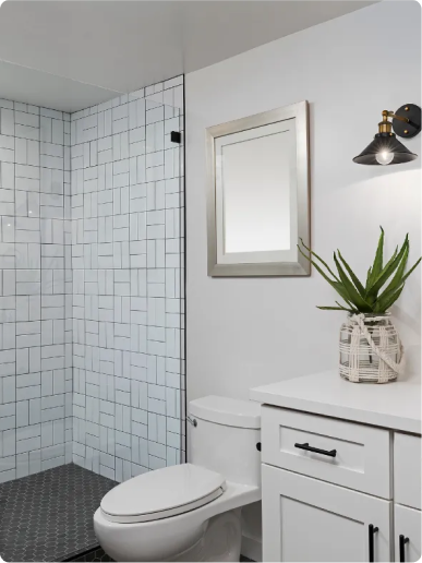 Master bathroom remodel in Stoneham, MA with Carrara marble tile, frameless glass shower and gold fixtures