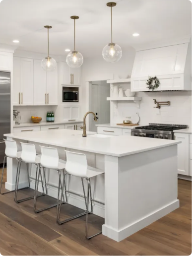 Kitchen remodel in Lexington, MA with white Shaker cabinets, quartz waterfall island and stainless appliances